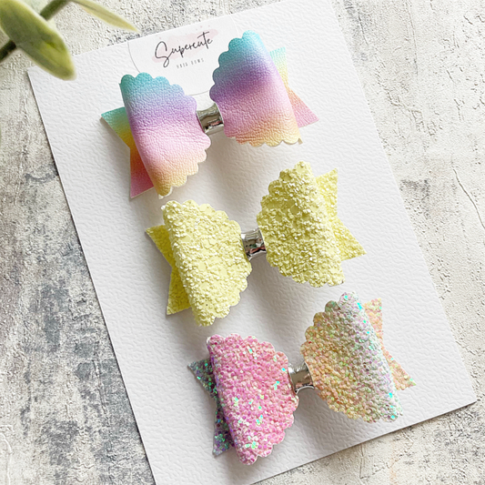 A set of 3 mini bows in ombré rainbow glitter and faux leather and a chunky lemon glitter 