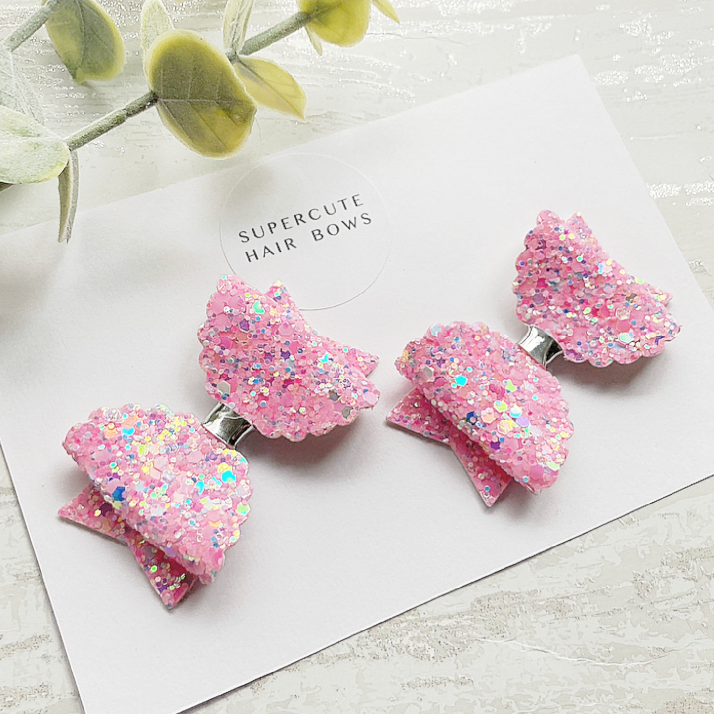 a pair of pink scalloped piggy bows 2.5" wide on mini alligator clips